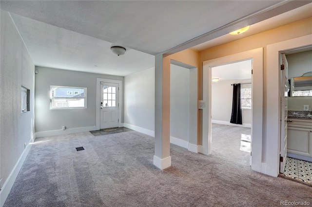 view of carpeted foyer entrance