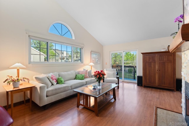 1470 S Quebec Way Unit 245, Denver, CO 80231 - living area with high vaulted ceiling, wood finished floors, and healthy amount of natural light