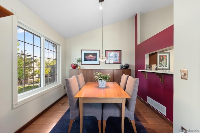 1470 S Quebec Way Unit 245, Denver, CO 80231 - dining room with wood finished floors, lofted ceiling, and baseboards