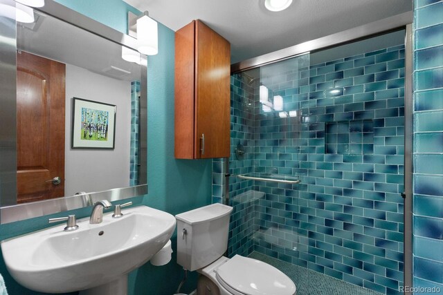 1470 S Quebec Way Unit 245, Denver, CO 80231 - full bathroom featuring a sink, a shower stall, and toilet