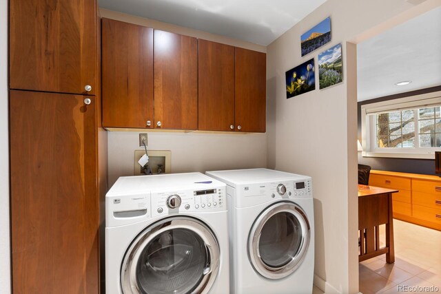 1470 S Quebec Way Unit 245, Denver, CO 80231 - clothes washing area with washer and dryer, cabinet space, and light tile patterned flooring