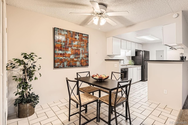 dining room featuring a textured ceiling and ceiling fan