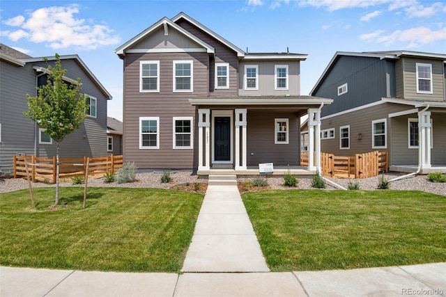 view of front of house featuring covered porch and a front lawn