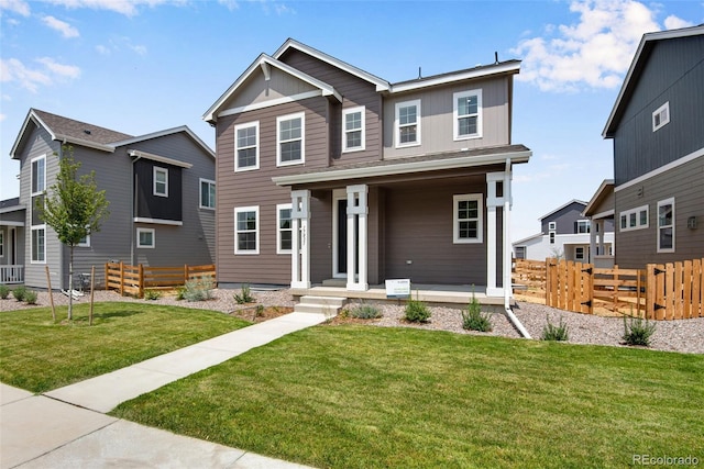 craftsman-style home with covered porch and a front lawn