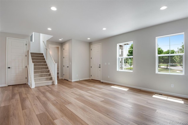 foyer entrance with plenty of natural light and light hardwood / wood-style flooring