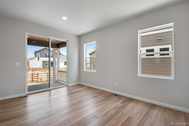 spare room with light hardwood / wood-style floors