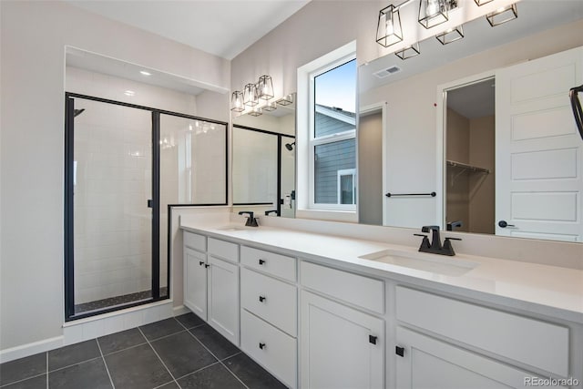 bathroom featuring vanity, an enclosed shower, and tile patterned flooring