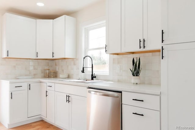 930 S Lowell Blvd, Denver, CO 80219 - kitchen featuring dishwasher, a sink, decorative backsplash, white cabinets, and light countertops