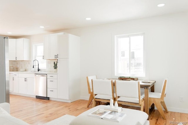 930 S Lowell Blvd, Denver, CO 80219 - dining space with light wood finished floors, baseboards, and recessed lighting