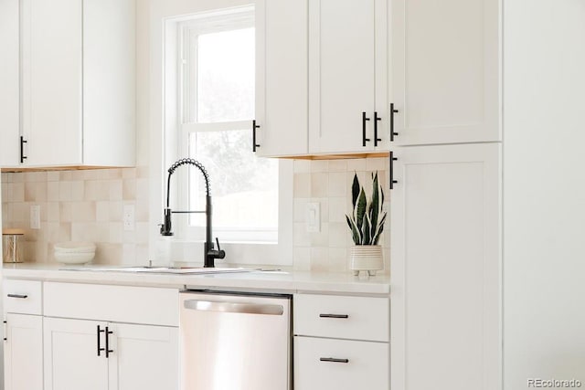 930 S Lowell Blvd, Denver, CO 80219 - kitchen featuring stainless steel dishwasher, a sink, decorative backsplash, and white cabinets