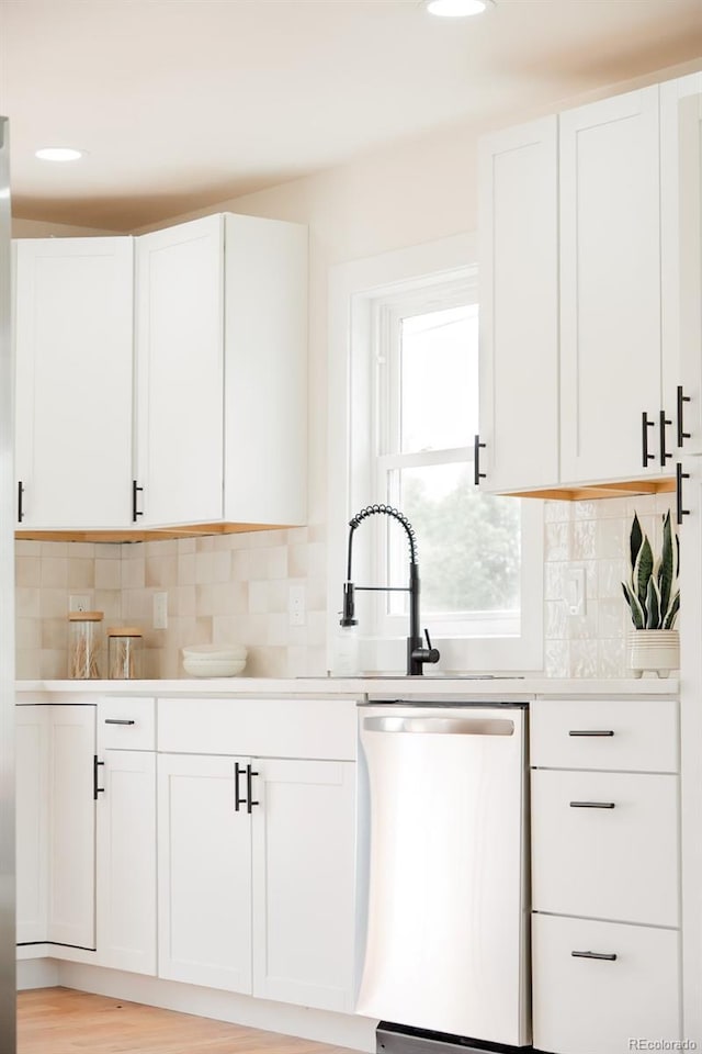 930 S Lowell Blvd, Denver, CO 80219 - kitchen with stainless steel dishwasher, white cabinetry, light countertops, and recessed lighting