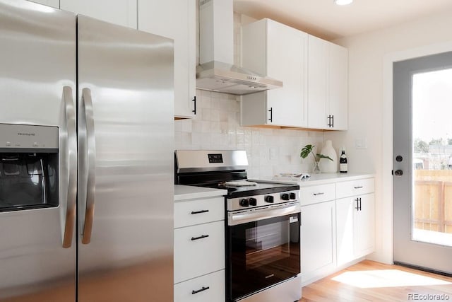 930 S Lowell Blvd, Denver, CO 80219 - kitchen with stainless steel appliances, wall chimney range hood, backsplash, and light countertops