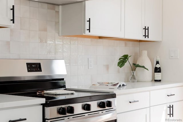 930 S Lowell Blvd, Denver, CO 80219 - kitchen featuring stainless steel electric range oven, decorative backsplash, light countertops, and white cabinetry