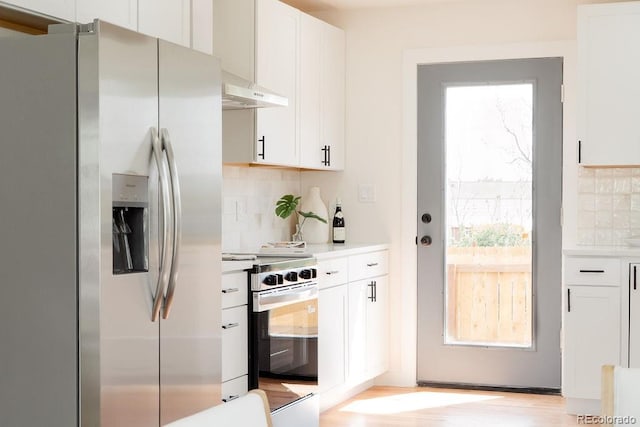 930 S Lowell Blvd, Denver, CO 80219 - kitchen featuring appliances with stainless steel finishes, tasteful backsplash, light countertops, and white cabinets