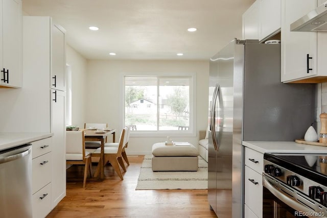 930 S Lowell Blvd, Denver, CO 80219 - kitchen with dishwasher, exhaust hood, light wood-style flooring, light countertops, and recessed lighting