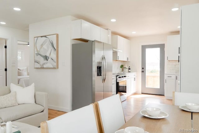 930 S Lowell Blvd, Denver, CO 80219 - kitchen featuring appliances with stainless steel finishes, light wood finished floors, tasteful backsplash, white cabinetry, and recessed lighting