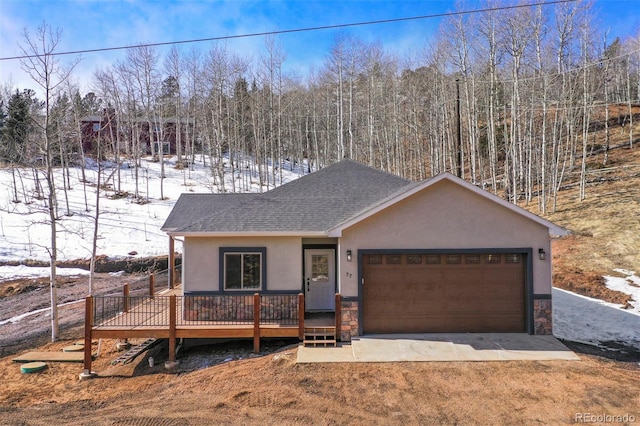 view of front of home with a wooden deck and a garage