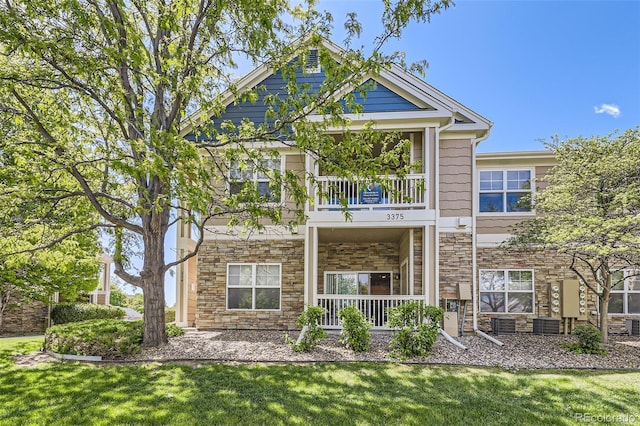 3375 Boulder Cir Unit 204, Broomfield, CO 80023 - view of front of house with stone siding, a balcony, and a front yard