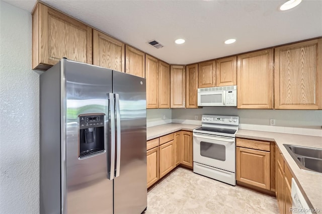 3375 Boulder Cir Unit 204, Broomfield, CO 80023 - kitchen with white appliances, recessed lighting, light countertops, light brown cabinets, and a sink