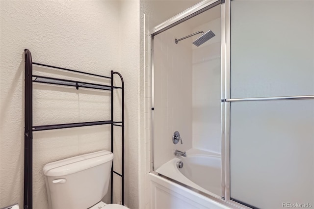3375 Boulder Cir Unit 204, Broomfield, CO 80023 - full bathroom featuring a textured wall, bath / shower combo with glass door, and toilet