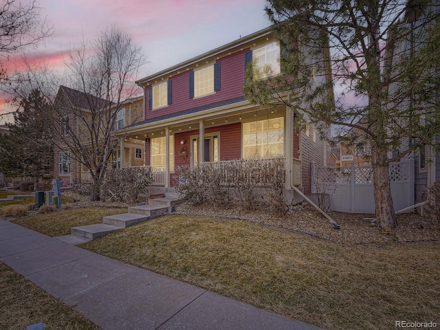 view of front facade with a porch and a lawn