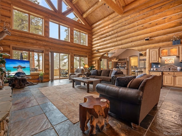 23076 Oehlmann Park Rd, Conifer, CO 80433 - living room with high vaulted ceiling, stone tile floors, arched walkways, a wooden ceiling with exposed beams, and log walls