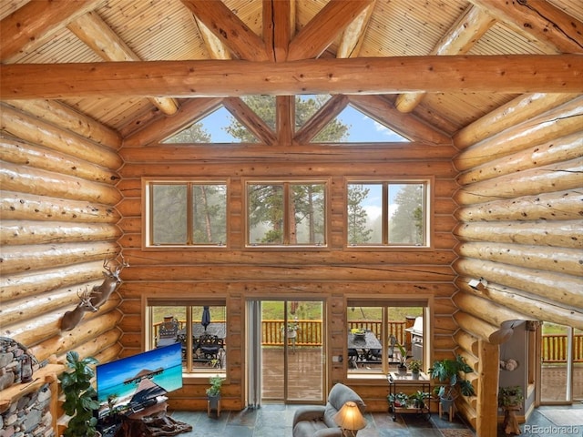 23076 Oehlmann Park Rd, Conifer, CO 80433 - interior space with plenty of natural light, high vaulted ceiling, a wooden ceiling with exposed beams, and log walls