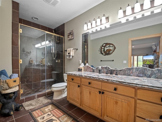 23076 Oehlmann Park Rd, Conifer, CO 80433 - full bathroom with vanity, tile patterned flooring, a stall shower, a textured wall, and a textured ceiling