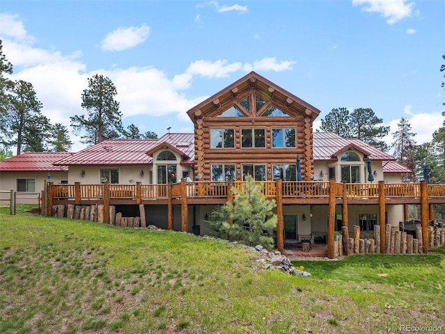 23076 Oehlmann Park Rd, Conifer, CO 80433 - rear view of property featuring stucco siding, a yard, a deck, and log siding