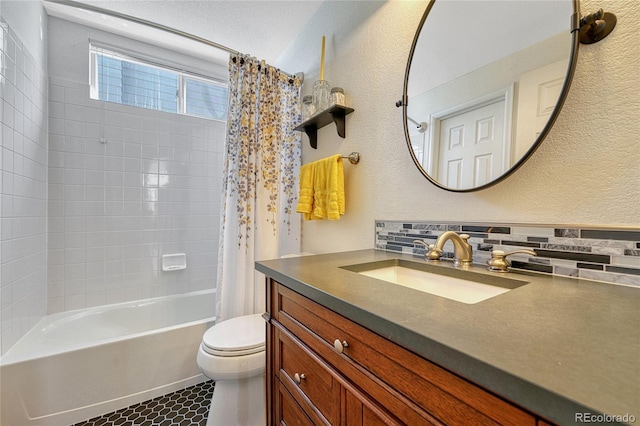 bathroom with shower / bath combination with curtain, a textured wall, decorative backsplash, toilet, and vanity