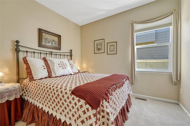 bedroom with baseboards, visible vents, and carpet flooring