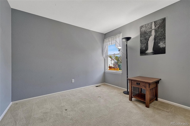 empty room with baseboards and carpet flooring