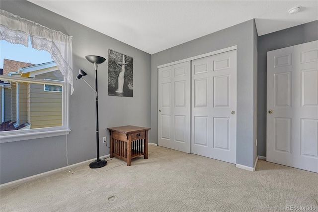 bedroom featuring a closet, carpet, and baseboards