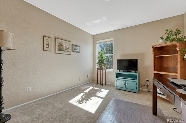 carpeted living room featuring baseboards