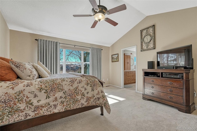 bedroom featuring lofted ceiling, connected bathroom, light carpet, a ceiling fan, and baseboards