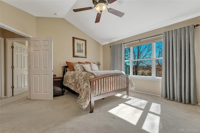 bedroom with a ceiling fan, light colored carpet, and vaulted ceiling