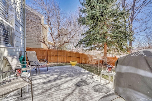 wooden deck featuring a patio, area for grilling, and a fenced backyard