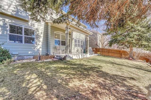 exterior space featuring a lawn and fence