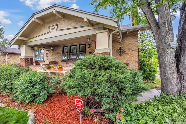 3242 Utica St, Denver, CO 80212 - view of front of house with brick siding and a porch