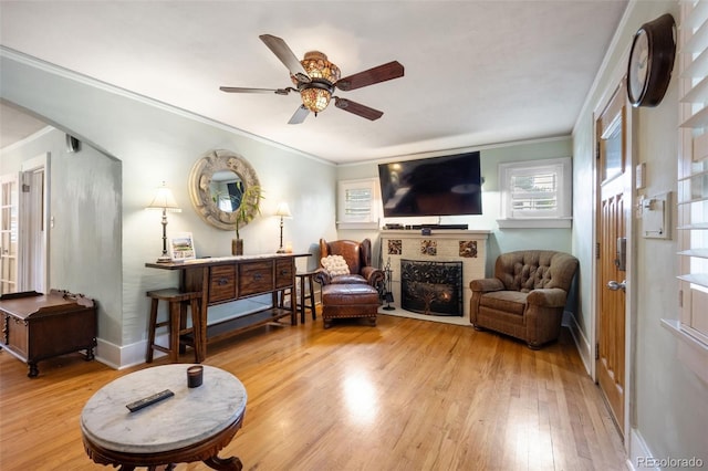3242 Utica St, Denver, CO 80212 - living area with wood finished floors, ornamental molding, a ceiling fan, a fireplace, and baseboards