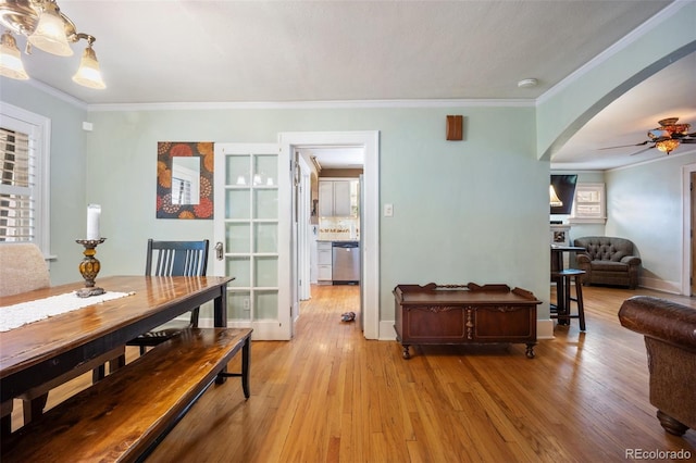 3242 Utica St, Denver, CO 80212 - dining room featuring light wood finished floors, a ceiling fan, arched walkways, ornamental molding, and baseboards
