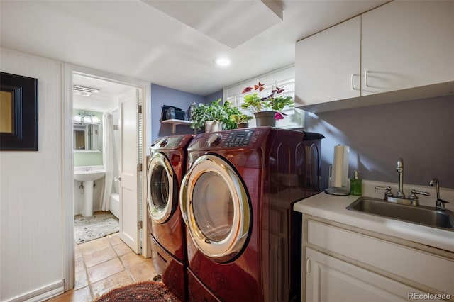 3242 Utica St, Denver, CO 80212 - laundry room with washing machine and clothes dryer, cabinet space, recessed lighting, light tile patterned floors, and baseboards