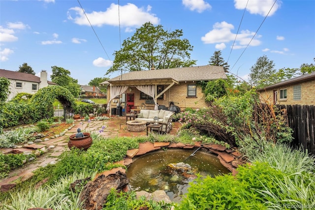 3242 Utica St, Denver, CO 80212 - view of yard featuring a garden pond, a patio, and an outdoor living space with a fire pit