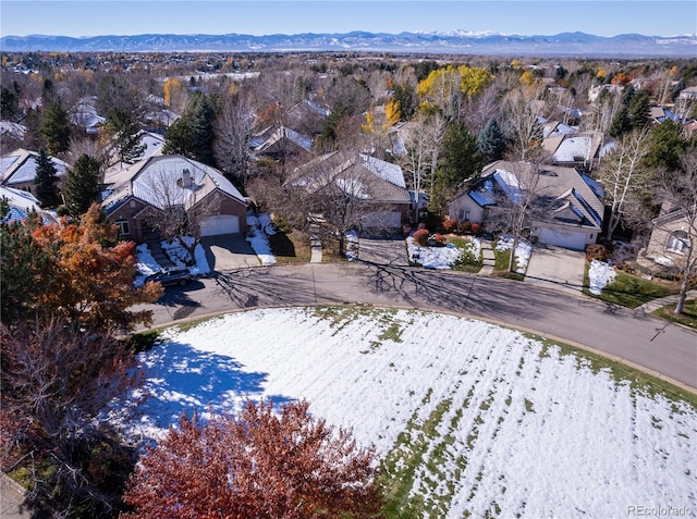 snowy aerial view featuring a mountain view