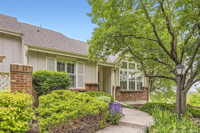 2980 W Long Dr Unit E, Littleton, CO 80120 - property entrance with brick siding, board and batten siding, and a shingled roof