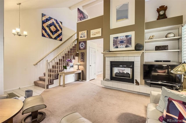 2980 W Long Dr Unit E, Littleton, CO 80120 - living area with high vaulted ceiling, stairway, a fireplace, baseboards, and a chandelier