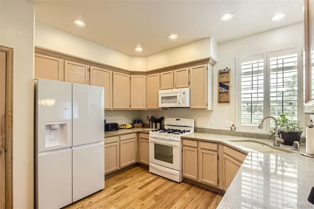 2980 W Long Dr Unit E, Littleton, CO 80120 - kitchen with white appliances, a sink, light wood-type flooring, recessed lighting, and light stone countertops