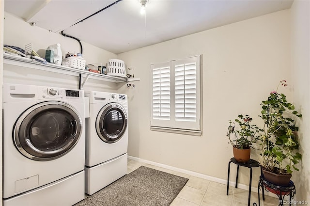 2980 W Long Dr Unit E, Littleton, CO 80120 - laundry room featuring washing machine and dryer, baseboards, and light tile patterned floors