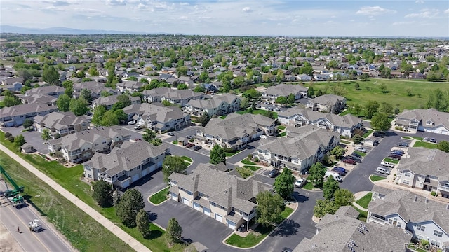 aerial view of property and surrounding area featuring nearby suburban area