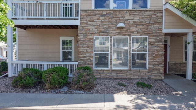 entrance to property featuring stone siding